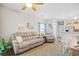 Comfortable living room showing a reclining sofa, fan, and adjacent dining and kitchen area at 5406 Sweetwater Blvd. # 5406, Murrells Inlet, SC 29576