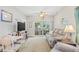 Inviting living room featuring wood floors, a reclining sofa, dining area, and access to outdoor patio at 5406 Sweetwater Blvd. # 5406, Murrells Inlet, SC 29576