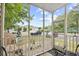 Relaxing screened porch with outdoor furniture and a view of the parking area at 5406 Sweetwater Blvd. # 5406, Murrells Inlet, SC 29576