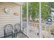 Relaxing screened porch with outdoor furniture, lifeguard ring, and view of a wooded area at 5406 Sweetwater Blvd. # 5406, Murrells Inlet, SC 29576
