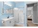 Bright blue bathroom with a vanity and a shower with sliding glass doors at 6001 - 1732 S Kings Hwy., Myrtle Beach, SC 29575