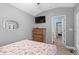 Comfortable bedroom featuring a wood dresser, TV, and a view into the doorway of the adjacent room at 6001 - 1732 S Kings Hwy., Myrtle Beach, SC 29575