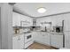 All-white kitchen featuring stainless sink, microwave, and ample cabinet and counter space for your cooking needs at 6001 - 1732 S Kings Hwy., Myrtle Beach, SC 29575