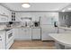 Bright kitchen with white appliances, stone backsplash, and plentiful cabinet space for all your cooking needs at 6001 - 1732 S Kings Hwy., Myrtle Beach, SC 29575