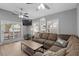 Inviting living room boasts a plush sectional, wood-look flooring, and ample natural light from the windows and doors at 6001 - 1732 S Kings Hwy., Myrtle Beach, SC 29575