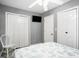 Cozy bedroom features light grey walls, two closets, a television, and a side chair at 6001-1833 S Kings Hwy., Myrtle Beach, SC 29575