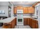 Bright kitchen features wood cabinets and white appliances at 6001-1833 S Kings Hwy., Myrtle Beach, SC 29575