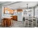 Bright kitchen features wood cabinets, white appliances, island with bar seating, and gray flooring at 6001-1833 S Kings Hwy., Myrtle Beach, SC 29575