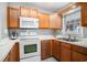 Bright kitchen features wood cabinets and white appliances at 6001-1833 S Kings Hwy., Myrtle Beach, SC 29575