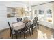 Dining room with a chandelier, a table with six chairs, white walls, and three decorative framed pictures at 6080 Zoe Way, Myrtle Beach, SC 29588