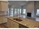 Open kitchen with granite counters, stainless appliances, and island seating overlooking the living room at 6080 Zoe Way, Myrtle Beach, SC 29588