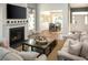 Cozy living room with fireplace, wood floors, and a view to the dining room at 6080 Zoe Way, Myrtle Beach, SC 29588