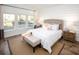 Bright bedroom with three large windows and a comfortable upholstered bed with a patterned bench at 6080 Zoe Way, Myrtle Beach, SC 29588