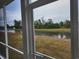 Screened patio view overlooking lush yard and a beautiful pond at 6080 Zoe Way, Myrtle Beach, SC 29588