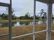 Serene pond view framed by a screened-in patio of an outdoor living space at 6080 Zoe Way, Myrtle Beach, SC 29588