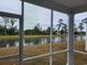 Screened-in porch view of the pond, trees and houses from an outdoor screened-in patio at 6080 Zoe Way, Myrtle Beach, SC 29588