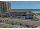 A condo complex with a gray facade is near a sandy beach and has ocean views at 613 S Ocean Blvd. # N3, North Myrtle Beach, SC 29582