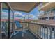 Balcony with a blue chair and scenic views of the surrounding buildings and sky at 613 S Ocean Blvd. # N3, North Myrtle Beach, SC 29582