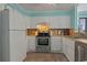Bright kitchen with white cabinets, stainless steel appliances, and ample countertop space at 613 S Ocean Blvd. # N3, North Myrtle Beach, SC 29582