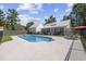 An expansive backyard offers a large pool, a covered patio, and fenced in yard at 62 Warbler St., Georgetown, SC 29440