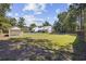Spacious backyard featuring an in-ground pool, shed, and expansive green space at 62 Warbler St., Georgetown, SC 29440
