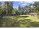The backyard offers ample space, featuring a swing set, trampoline, and storage shed at 62 Warbler St., Georgetown, SC 29440