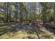 View of sprawling backyard featuring mature trees and wood fence at 62 Warbler St., Georgetown, SC 29440