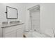 Functional bathroom with a granite countertop sink, shower, large mirror, and ample storage at 62 Warbler St., Georgetown, SC 29440