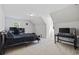 Neutral bedroom with large window, carpeted floors, and a bed, desk, and tv for comfort and convenience at 62 Warbler St., Georgetown, SC 29440