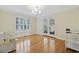 Bright and airy dining room features hardwood floors, large windows, and stylish chandelier at 62 Warbler St., Georgetown, SC 29440