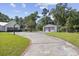 Long driveway to a two-car garage and a separate outbuilding with dual roll-up doors at 62 Warbler St., Georgetown, SC 29440