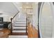 Inviting entryway with hardwood floors, staircase with white banister and open access to other rooms at 62 Warbler St., Georgetown, SC 29440