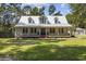Charming one-story home featuring a metal roof, double-door entrance, and inviting front porch at 62 Warbler St., Georgetown, SC 29440