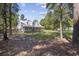 Quaint one-story home, surrounded by mature trees and lush greenery, exudes warmth and privacy at 62 Warbler St., Georgetown, SC 29440