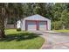 A metal garage with dual roll-up doors provides convenient storage at 62 Warbler St., Georgetown, SC 29440