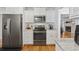 Modern kitchen with stainless steel appliances, white cabinets, and marble countertops at 62 Warbler St., Georgetown, SC 29440