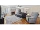 Cozy living room with a brick fireplace, hardwood floors, and comfortable seating arrangement at 62 Warbler St., Georgetown, SC 29440