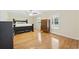 Spacious main bedroom featuring hardwood floors, a dark wood bed frame, and multiple windows for natural light at 62 Warbler St., Georgetown, SC 29440