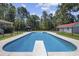 Dive into the in-ground pool with diving board, perfect for cooling off on a hot day at 62 Warbler St., Georgetown, SC 29440