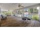 Large screened-in porch featuring a pool and yard view, plus a table and chairs and two ceiling fans at 62 Warbler St., Georgetown, SC 29440