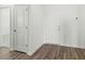 Clean entryway featuring wood-look flooring and white doors leading to various rooms at 622 Castillo Dr., Loris, SC 29569
