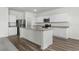 Open-concept kitchen featuring a functional island with a sink, modern appliances, and granite countertops at 622 Castillo Dr., Loris, SC 29569