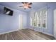 Bedroom with a ceiling fan, television, windows, and new floors at 6244 Catalina Dr. # 511, North Myrtle Beach, SC 29582