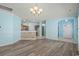 Well-lit dining area with an open view into the kitchen features bright paint and lovely chandelier at 6244 Catalina Dr. # 511, North Myrtle Beach, SC 29582