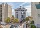 Exterior of a three-story building with ocean view balconies surrounded by palm trees and parking at 6244 Catalina Dr. # 511, North Myrtle Beach, SC 29582