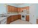 Kitchen shows matching appliances, cabinets, and countertops with mosaic tile backsplash at 6244 Catalina Dr. # 511, North Myrtle Beach, SC 29582