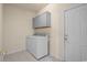 A laundry room with cabinets and a washer and dryer at 6244 Catalina Dr. # 511, North Myrtle Beach, SC 29582