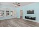 Open floor plan shows a lovely living room with mounted television, ceiling fan, and bright paint at 6244 Catalina Dr. # 511, North Myrtle Beach, SC 29582
