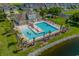 Resort style pool with lounge chairs surrounded by lush landscaping and palm trees at 6244 Catalina Dr. # 511, North Myrtle Beach, SC 29582