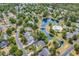 Beautiful aerial showcasing homes by a pond and community pool surrounded by trees at 67 Camden Circle, Pawleys Island, SC 29585